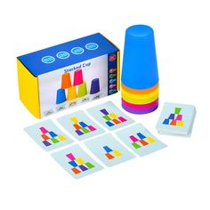 a set of colored stickers and matching cups in front of a box with the contents