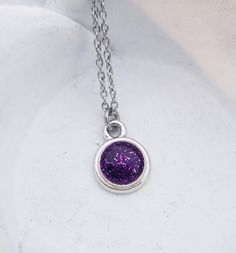 "Cremation Necklace - Pet Loss Gift - Ashes Jewelry - Memorial Jewelry - Pet Cremation Jewelry - Memorial Keepsake - Glitter Ashes - Dainty This beautiful, dainty necklace is made using your beloved pet's actual ashes. You may be able to see the ashes, but I will add a touch of glitter to highlight the piece. The disc pendant is approximately 1/2\" and graces a dainty stainless steel link chain. Please contact us after you've ordered for instructions on how/where to ship the ashes for your neckl Sparkling Purple Jewelry For Gift, Sparkling Purple Jewelry Gift, Glitter Round Jewelry As Gift, Round Glitter Jewelry As Gift, Silver Glitter Necklace For Gift, Round Glitter Jewelry For Gifts, Purple Glitter Party Jewelry, Purple Glitter Jewelry Gift, Purple Glitter Jewelry For Gifts