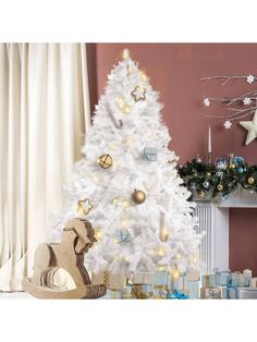 a white christmas tree with gold and silver ornaments