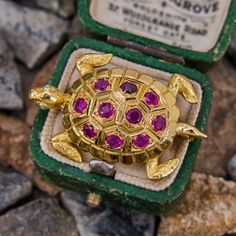 This charming French made turtle brooch features an 18k yellow gold shell set with a ten round cut ruby accents. The eye are round cabochon turquoise colored glass. The brooch is finished with an 18k yellow gold trumpet clasp pin back. It is stamped with a French eagles head. Vintage Ruby Rings, Antique Engagement Rings Sapphire, Ruby Ring Vintage, Estate Jewelry Rings, Turtle Brooch, Wedding Ring Diamond Band, Ruby Rings, Ruby Diamond Rings, Engagement Sets