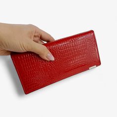 Upgrade your accessory collection with this elegant long women's wallet, crafted from high-quality leather. This sleek wallet is designed to keep all your essentials organized, featuring multiple compartments for credit cards, a driver's license, and other important documents, as well as a dedicated space for coins. The vibrant red color adds a bold touch to your style, making this wallet a standout piece. Premium Quality & Materials: Made from top-quality leather, this wallet offers durability and a luxurious texture. Its sophisticated design is both stylish and functional, making it an excellent choice for daily use. Practical Design: With external dimensions of 18.5 cm (width) x 8.5 cm (height) x 3 cm (thickness), this wallet is spacious enough to hold your essentials without being bulk Important Documents, Documents Organization, Clip Wallet, Practical Design, Long Red, Money Clip Wallet, Sophisticated Design, Vibrant Red, High Quality Leather