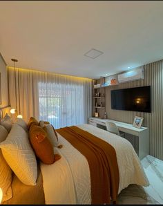 a bedroom with a large bed and a flat screen tv mounted on the wall above it