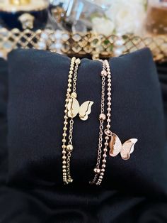 Our Beautiful Butterfly Beaded Two Double Chain Bracelet in Gold & Rose Gold Colour is the perfect blend of style and sophistication.  Made with high-quality materials, this chain exudes luxury and is sure to make a statement. - Stainless Steel - Non-Tarnish  - Nickel Free  - Water Resistant  The classic design is timeless and will never go out of style. It's the perfect accessory for any occasion, whether you're dressing up for a night out or just want to add a touch of glam to your everyday lo Trendy Rose Gold Bracelet With Delicate Chain, Elegant Beaded Bracelets With Adjustable Chain For Party, Rose Gold Jewelry With Double Chain, Elegant Beaded Metal Charm Bracelet, Trendy Rose Gold Metal Chain Bracelet, Elegant Party Bracelets With Beaded Chain, Trendy Rose Gold Charm Bracelet For Party, Trendy Beaded Bracelet With Chain For Gift, Elegant Beaded Chain Bracelets For Party