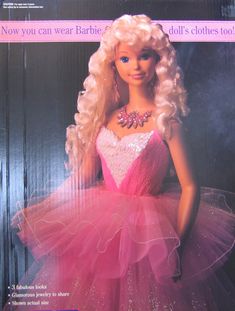 the barbie doll is wearing a pink dress