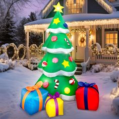 a christmas tree and presents in front of a house