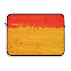 an orange and yellow painting on the side of a laptop