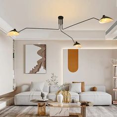 a living room filled with white furniture and lots of lights on the ceiling above it