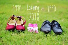 two pairs of shoes sitting in the grass next to each other with their names on them