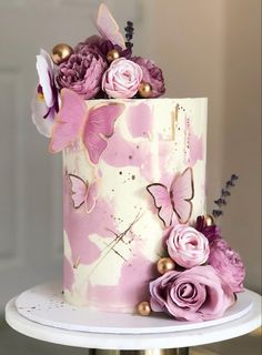 a pink and white cake decorated with flowers