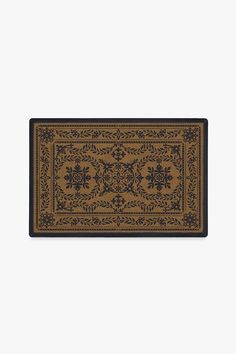 a brown and black rug with an ornate design on the bottom, in front of a white background