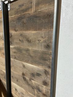 a close up of a wooden door with metal bars on the outside and wood planks on the inside