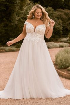 a woman in a white wedding dress posing for the camera with her hand on her hip