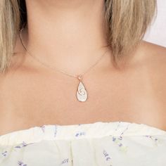 This 925 sterling silver teardrop pendant features our original Nalu, or wave, motif paired with pavé white topaz gemstones. Waves are a symbol of constant movement, like the flow of life. These represent the energy beyond what we see. Under that outer layer, there are cold and warm currents, tidal waves, and even life. The teardrop shape of this piece emphasizes that water is our life-force- oceans, rain, and our joyful tears are water. The perfect gift to show how much your love has continued Engraved White Gold Teardrop Jewelry, Personalized White Teardrop Jewelry, Teardrop Pendant With Rose Cut Diamonds For Gifts, Rose Gold Teardrop Sterling Silver Jewelry, Teardrop Rose Cut Diamond Necklaces For Gifts, Gift Rose Cut Diamond Teardrop Necklaces, White Drop Necklace With Diamond Accents For Gift, Silver Teardrop Birthstone Drop Necklace, Rose Cut Diamonds Teardrop Pendant