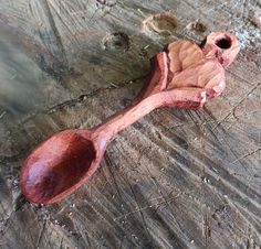 a wooden spoon sitting on top of a piece of wood