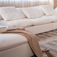 a living room with a white couch and rug