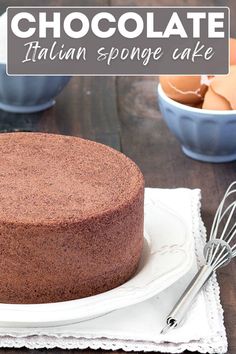 a chocolate cake sitting on top of a white plate next to an egg in a bowl