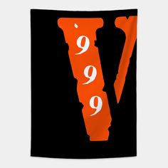 an orange and black wall hanging with the letter v in white on it's side