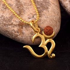 Om Pendant with Five Mukhi Nepali Rudraksha. Rudraksha is good For Health and wealth. Gross Wt. 6.59 Gms Festive Gold Mala As Gift, Festive Gold Mala For Gift, Gold Mala As Navratri Gift, Gold Mala For Navratri Gift, Spiritual 22k Gold Temple Necklace As Gift, Gold Mala With Latkans For Festivals, Gold Mala With Tilla For Diwali, 22k Gold Temple Necklace For Gift, Spiritual Style, Gold Mala For Navratri Rituals