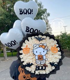 hello kitty balloon bouquet with balloons in the shape of heart shaped animals and letters that spell out boo