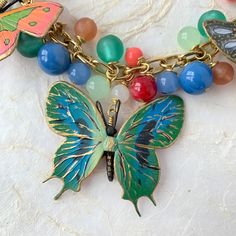 Multicolor Butterfly Charm Necklaces, Bohemian Necklace With Butterfly Charm, Green Butterfly Charm Necklace, Multicolor Butterfly Charm Jewelry, Bohemian Multicolor Enamel Necklaces, Bohemian Multicolor Enamel Necklace, Green Butterfly Charm Pendant Necklace, Elegant Multicolor Jewelry With Butterfly Charm, Elegant Multicolor Butterfly Charm Jewelry