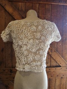 "This is an antique Irish lace blouse, from around 1910-20. The flowers are outstanding, so dimensional and different. There are no closures, goes over your head. The hem is accented with filet lace. There are a few broken threads here and there. I did not launder or press this blouse, just presenting it as found. Comes from a smoke free home. Measurements: Bust: 38\" Waist: 34\" Hip: 42\" Across Shoulder: 15.5\" Back Length: 16.5\" Please ask me any questions you may have before buying as this Victorian Fitted Scalloped Lace, Vintage Lace Patchwork Top, Vintage Lace Top With Lace Collar, Short Sleeve Lace Top With Lace Trim For Wedding, Lace Wedding Top With Lace Collar, Wedding Lace Top With Short Sleeves, Fitted Vintage Cream Lace Top, Vintage Cream Lace Top, Vintage Fitted Cream Lace Top