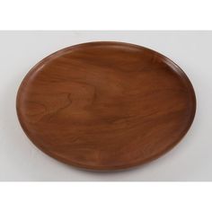 a wooden plate sitting on top of a white table