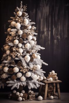 a white christmas tree with balls and pine cones