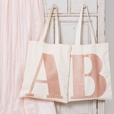 A super special glitter Alphabet Bags Collection! Every lovely letter of the alphabet printed big and bold with super sparkly rose gold glitter on natural cotton.Our bags have mid-length straps which are ideal for being carried by hand or over the shoulder.Lovingly stitched and printed in the UK using terrific heavy weight cotton. Made in the UK Heavy weight natural cotton Printed with rose gold glitter Mid-length handles 360mm by 420mm (14¼ by 16½ inches) Initial Tote Bag, Lovely Letter, Valentines Day Birthday, Round Leather, Rose Gold Glitter, Big Bags, Original Gift, Wash Bags, Cotton Totes