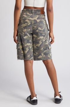 Channel laid-back skater style with these baggy denim shorts featuring camo print, a plethora of cargo pockets and raw hems for a lived-in look. 12" inseam; 12" rise Zip fly with button closure Five-pocket style; cargo flap-patch pockets 94% cotton, 5% polyester, 1% spandex Machine wash, tumble dry Imported Streetwear Short Length Cargo Jeans, Short Length Cargo Jeans For Streetwear, Utility Jean Shorts With Cargo Pockets For Streetwear, Utility Jean Shorts With Side Pockets, Casual High Rise Cargo Shorts With Pockets, Camouflage Relaxed Fit Utility Bottoms, Trendy Camouflage Shorts With Pockets, Utility Jean Shorts For Streetwear, Relaxed Fit Camouflage Bottoms With Cargo Pockets