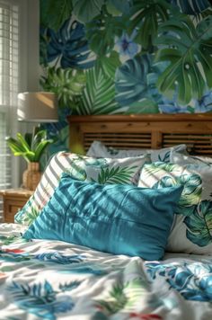 a bed with blue and green pillows on top of it