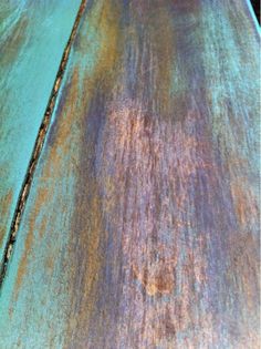 an old wooden table with rusted paint on it's edges and the top