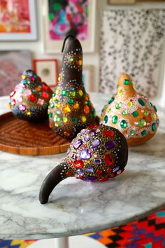 three decorative objects sitting on top of a marble table