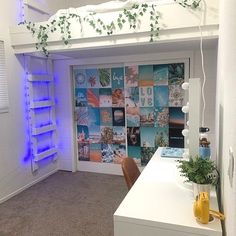 a room with a desk and some plants on the wall