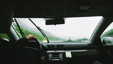 two people driving in the rain on a rainy day