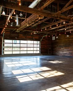 an empty room with exposed beams and lights