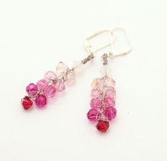 pink and red glass beaded earrings on white background