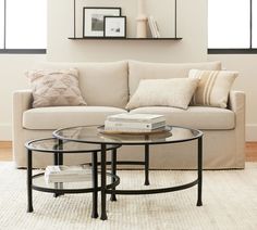 a living room with a couch, coffee table and books