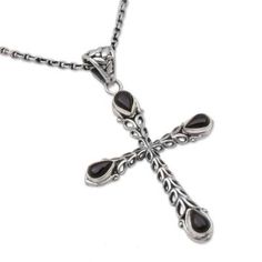 A sterling silver cross is elaborated with drop motifs handcrafted by Yuniati and other Balinese artisans. Giving the pendant a combination finish the artisans elaborate the pendant with petite droplets of black onyx stones. The pendant centers a length of cable chain for a striking and spiritual accessory. Black Sterling Silver Cross Necklace, Black Sterling Silver Cross Pendant Necklace, Spiritual Black Sterling Silver Cross Necklace, Spiritual Onyx Cross Jewelry, Petite Earrings, Onyx Pendant, Sterling Silver Cross Pendant, Silver Cross Pendant, Black Onyx Stone