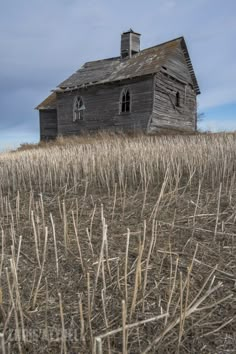 an old house in the middle of a field