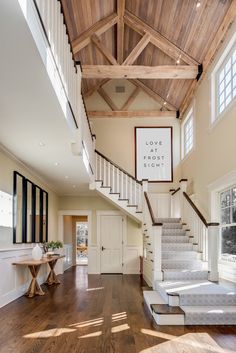 a large open floor plan with stairs leading up to the second story