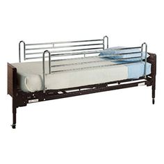 a metal bed frame with two mattresses on each side and no sheets in the middle