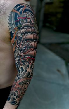 a man's half sleeve with an old ship tattoo on his arm and shoulder