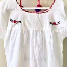 This traditional Mexican blouse is beautifully made in Merida Yucatan, Mexico, each piece is individually hand made and hand embroidered. You will love this lightweight blouse made of organic cotton, this natural material gives the blouse a delicate and relaxed feel. Details: Size M-L measurements: Bust: 42” - 29” length(shoulder to bottom Hem) Cotton thread Embroidered Material: 100% Cotton All items are shipped from the US All Mi Mundo Mexicano items are 100% handmade by artisans in Mexico. Ea White Folk Blouse With Resham Embroidery, Traditional White Embroidered Top, White Cotton Peasant Top With Embroidered Neckline, White Cotton Festival Peasant Top, Traditional White Blouse With Embroidered Hem, White Cotton Blouse With Embroidered Hem, White Cotton Peasant Top For Festival, Peasant Style Cotton Blouse With Yoke, Peasant Style Cotton Blouse With Yoke Detail