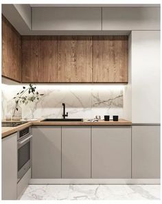 a kitchen with marble counter tops and wooden cabinets