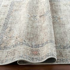 an area rug on top of a wooden floor