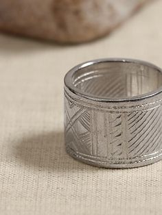 Part talisman, part adornment, the traditional engravings adorning both the inside and outside of this ring are a testament to the traditional craftsmanship of Tuareg artisans.  ETHNOPUR: Ethnopur works with and supports artisans from around the wor Traditional Carved Rings For Ceremonial Occasions, Traditional Carved Ceremonial Rings, Bohemian Wide Band Engraved Jewelry, Traditional Sterling Silver Engraved Ring For Ceremonial Occasions, Traditional Ceremonial Ring Jewelry, Traditional White Gold Engraved Ring, Traditional Etched White Gold Rings, Artisan Etched Ring Jewelry, Artisan Etched Jewelry For Wedding