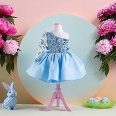 "Enchanting Elegance: The Perfect Easter Outfit for Your Little Princess Dress your darling in the magic of spring with our breathtaking \"Enchanting Elegance\" Easter dress. Designed with the festive spirit and playful charm of Easter in mind, this dress is a fairy-tale come to life. The soft, serene blue hue whispers of spring skies, while the floral accents bloom like the season's first flowers. This outfit isn't just a dress; it's a canvas of spring's awakening, perfect for Easter celebrations and memorable photographs. Springtime Splendor: A Fairy-tale Dress for an Unforgettable Easter Imagine your little girl twirling in a dress that captures the essence of a springtime fairy-tale. Our \"Springtime Splendor\" Easter dress is a wonderland of soft, flowing fabrics and delicate, hand-se Blue Floral Applique Dress For Dress-up, Elegant Light Blue Dress With Floral Applique, Blue Princess Style Party Dress, Elegant Blue Princess Dress For Dress-up, Princess Light Blue Pageant Dress, Blue Floral Applique Wedding Dress, Blue Wedding Dress With Floral Applique, Spring Princess Pageant Dress, Blue Princess Pageant Dress