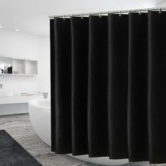 a black shower curtain in a bathroom with a white tub and sink behind it on carpeted flooring