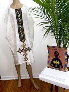 Dress White Bohemian Kaftan For Traditional Ceremonies, Bohemian Embroidered Habesha Kemis For Festival, White Bohemian Ceremonial Dress, White Bohemian Dress For Ceremonial Use, Folk Style Habesha Kemis For Festivals, White Bohemian Dress For Ceremonial Occasions, White Tunic Kaftan For Festivals, White Folk Kaftan For Traditional Ceremonies, White Folk Kaftan With Traditional Patterns