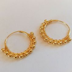 Pair of 2 cm diameter Hoop Earrings made in Sterling Silver with gold plating. These earrings are decorated with 3mm diameter beads set along the hoop. They are very elegant and original earrings that favor your face by providing light and harmony. They are made of 925 Sterling silver and have an 18 carat Gold plating that gives it a very elegant finish. The type of closure is Congo. The indicated price is for the PAIR of Earrings (right ear and left ear) Metal Hoop Beaded Earrings For Pierced Ears, Metal Hoop Beaded Earrings, Adjustable Hoop Earrings With Ear Wire, Adjustable Hoop Earrings For Pierced Ears, Beaded Metal Hoop Earrings, Hypoallergenic Adjustable Hoop Earrings, Brass Hoop Wrap Earrings, Brass Beaded Hoop Earrings As Gift, Handmade Brass Hoop Huggie Earrings